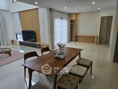 Spacious modern living room with elegant dining area and natural light