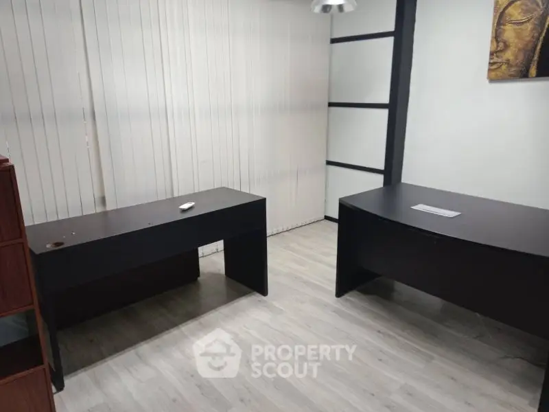 Modern office space with two sleek desks and minimalist decor