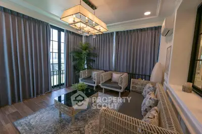 Elegant living room with modern decor and large windows in a stylish apartment.