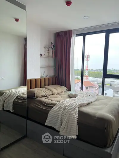 Cozy bedroom with large window offering stunning city view, modern decor, and plush bedding for ultimate comfort.