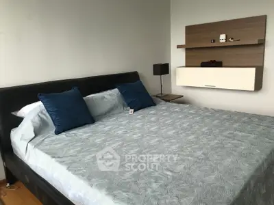 Spacious bedroom with modern decor and cozy bedding, perfect for relaxation.
