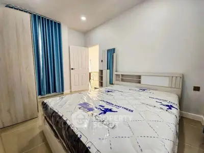 Spacious bedroom with modern decor and natural light, featuring a comfortable bed and stylish wardrobe.