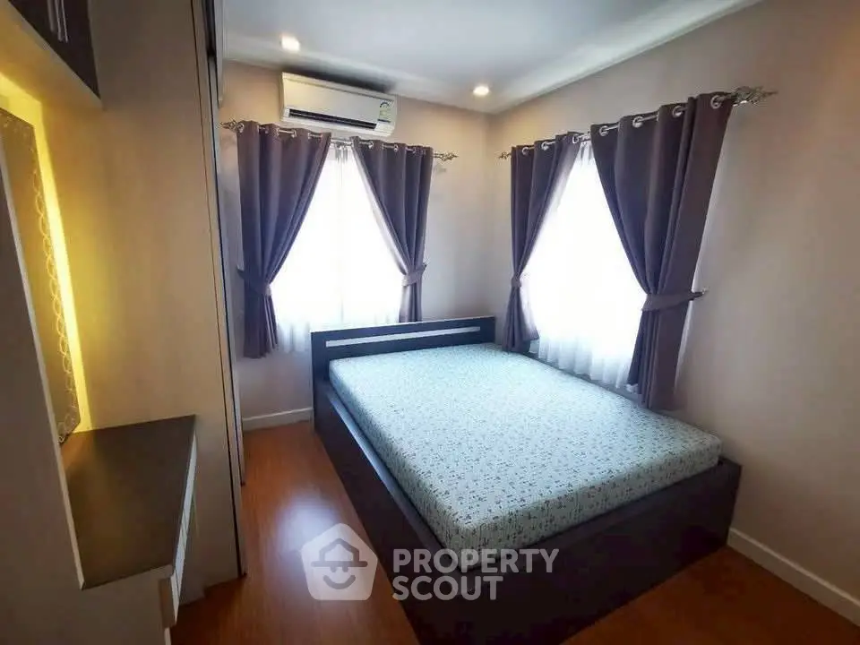 Cozy bedroom with modern decor and ample natural light