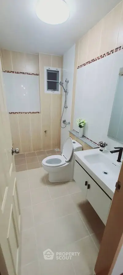 Modern bathroom with sleek fixtures and neutral tiles