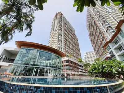 Luxurious high-rise apartment complex with stunning pool and modern architecture.