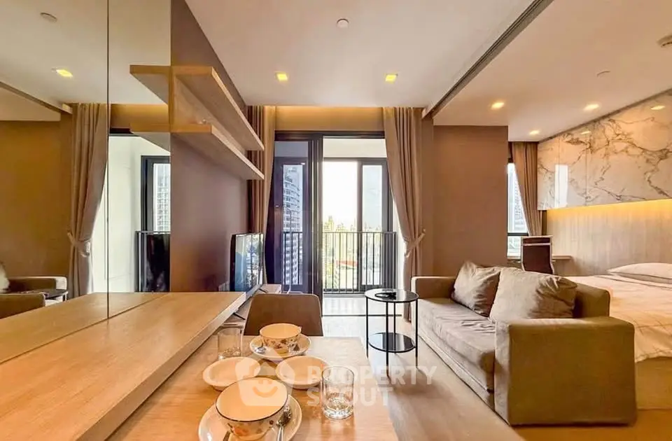 Modern living room with balcony, stylish decor, and natural light.