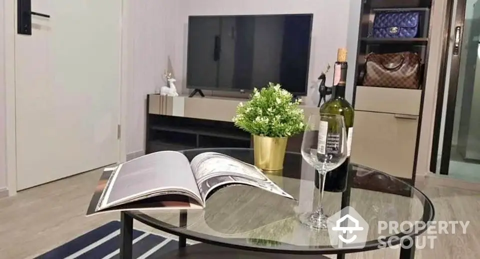 Stylish living room with modern decor, TV, and elegant coffee table setup.