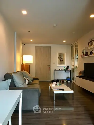 Modern living room with cozy sofa, sleek TV unit, and stylish decor in a contemporary apartment.