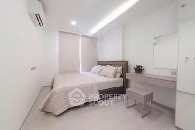 Modern minimalist bedroom with sleek design and neutral tones, featuring a comfortable bed and stylish decor.