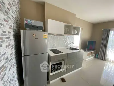 Modern kitchen with sleek appliances and open layout in a stylish apartment.