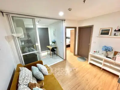 Modern living room with cozy sofa and stylish decor in open layout apartment.