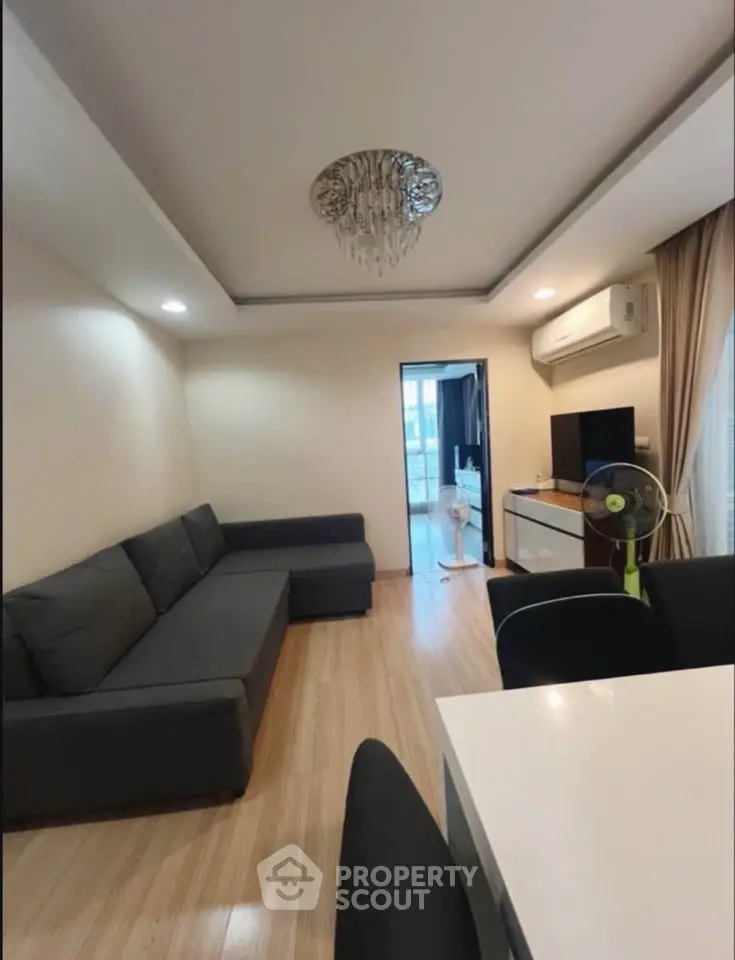 Modern living room with sleek furniture and elegant lighting in a stylish apartment.