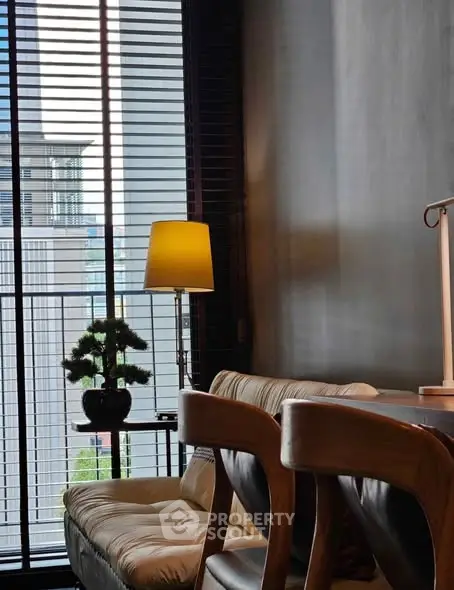 Chic modern living room with stylish furniture and large window blinds