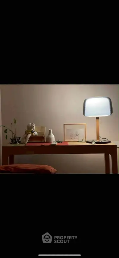 Cozy study nook with modern lamp and minimalist decor, perfect for focused work or reading.