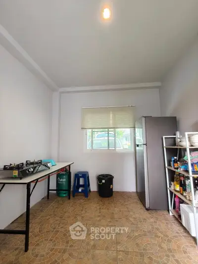 Spacious kitchen with gas stove and ample storage space