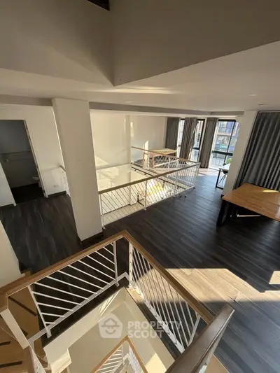 Spacious modern duplex with elegant staircase and abundant natural light