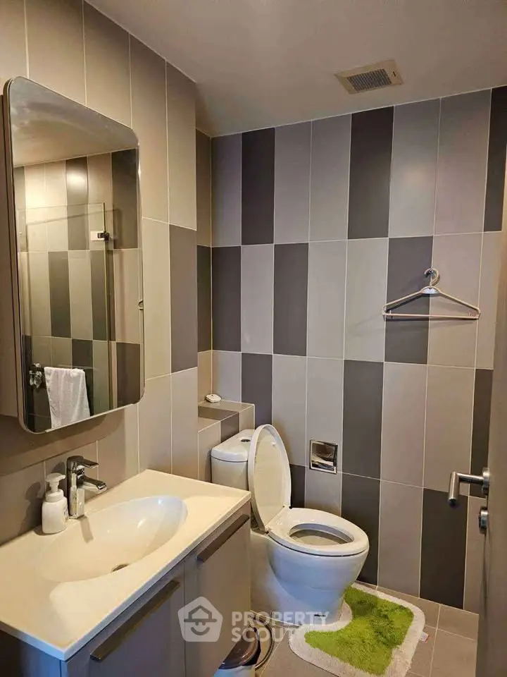Modern bathroom with stylish tiles and sleek fixtures, perfect for contemporary living.