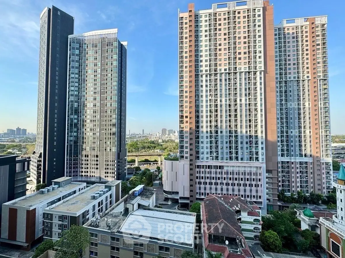 Stunning cityscape view of modern high-rise residential buildings with clear blue sky.