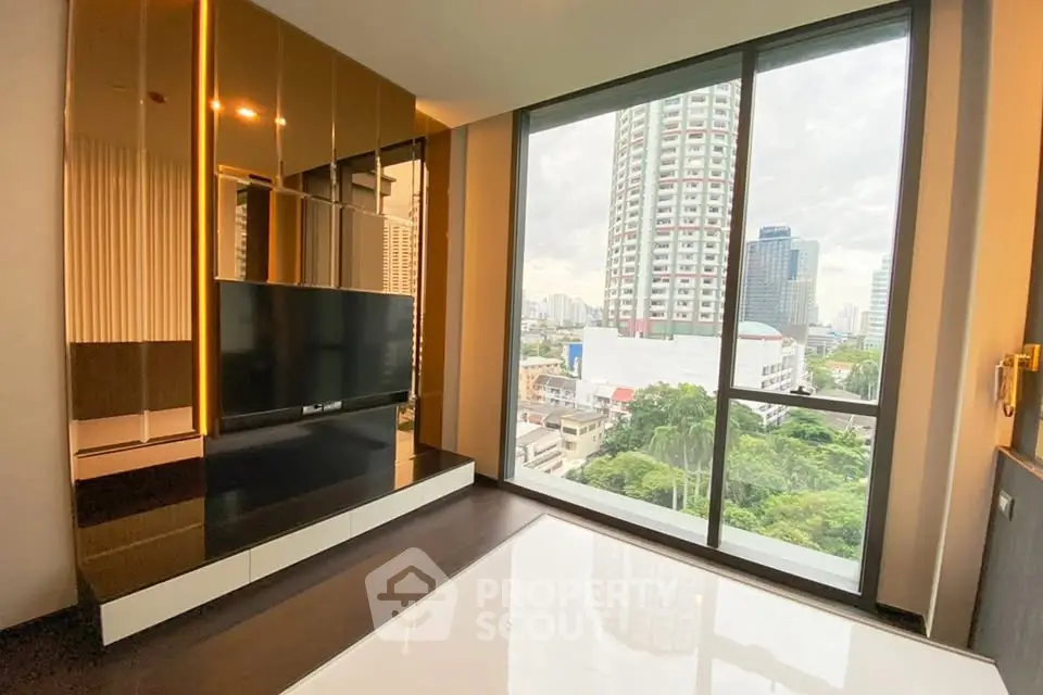 Modern living room with floor-to-ceiling windows offering stunning city views in a high-rise apartment.