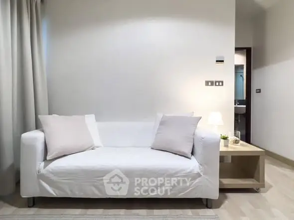 Modern living room with white sofa and minimalist decor