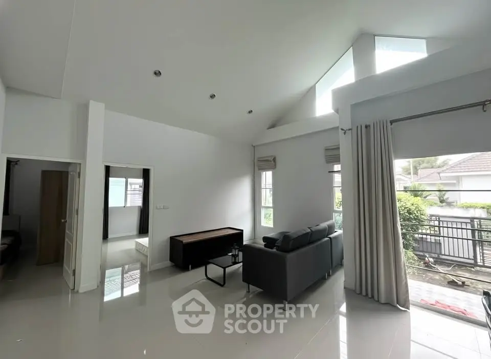 Spacious modern living room with high ceilings and natural light