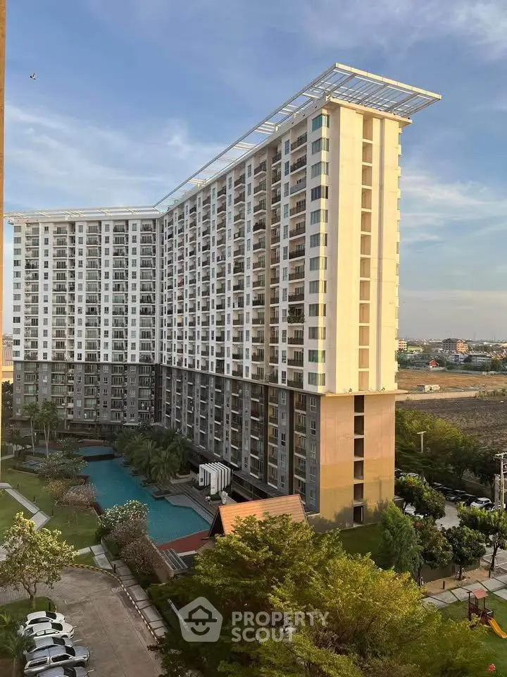 Stunning high-rise building with pool and lush greenery, offering modern urban living with breathtaking views.