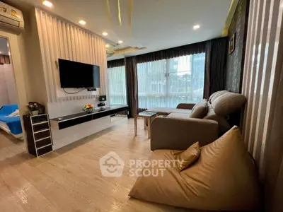 Modern living room with stylish decor and large windows offering natural light.