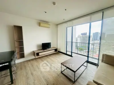 Modern living room with city view, featuring sleek furniture and large windows for natural light.