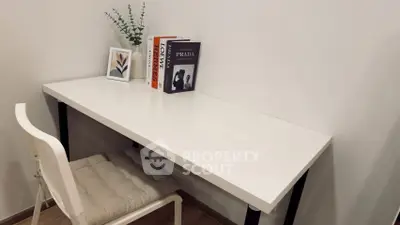 Minimalist study area with white desk and chair, perfect for productivity.