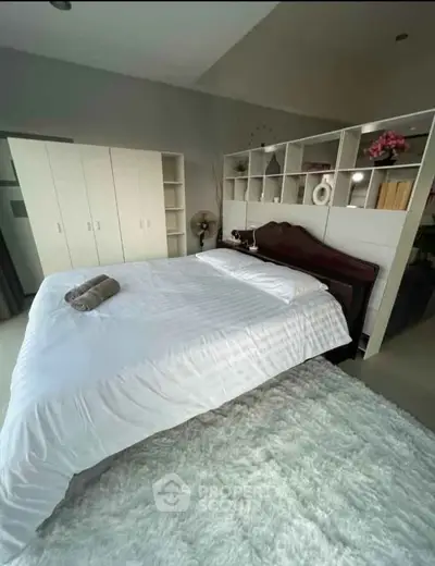 Spacious bedroom with elegant decor and ample storage space.
