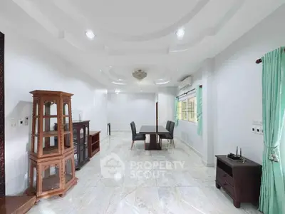 Spacious living room with elegant ceiling design and marble flooring