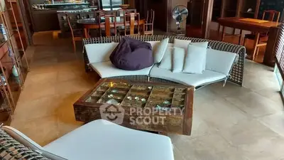 Luxurious living room with modern furniture and unique coffee table design.