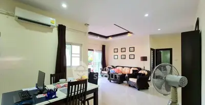 Spacious living room with modern decor and natural light, perfect for family gatherings.
