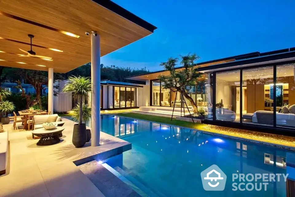 Luxurious modern villa with stunning pool and elegant outdoor living space at dusk.