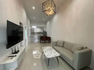 Modern living room with sleek furniture and open kitchen layout