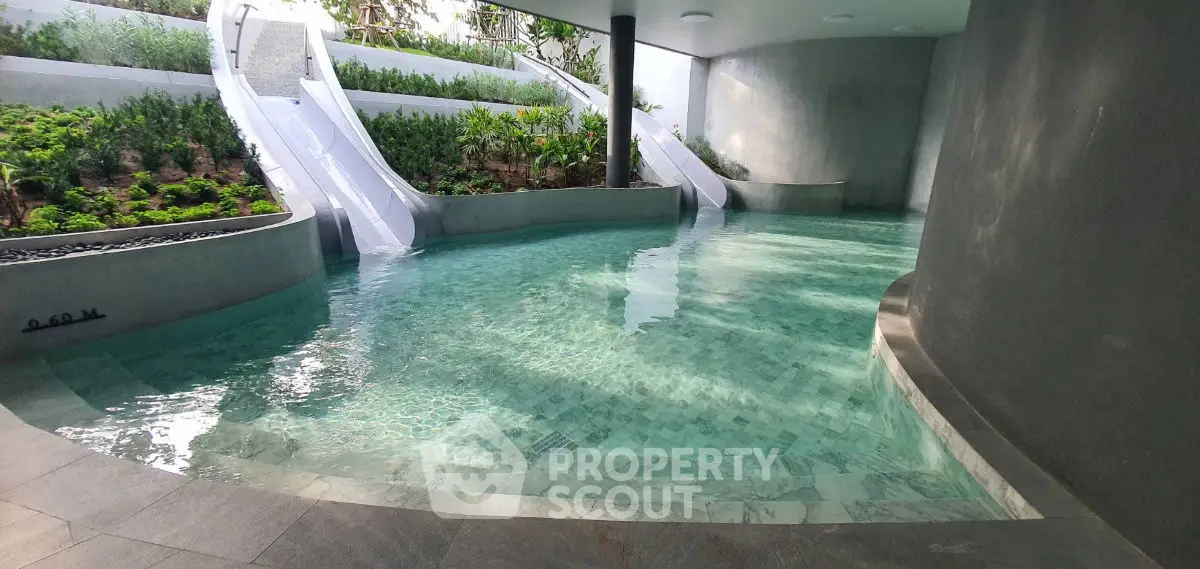 Luxurious indoor pool with modern design and lush greenery, perfect for relaxation and leisure.