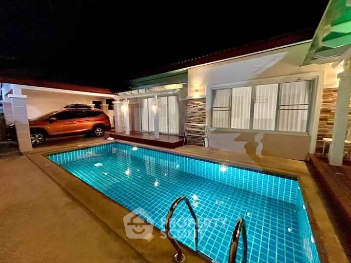 Charming night view of a cozy home with a private pool and carport.