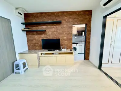 Modern living room with stylish TV unit and open view to kitchen area