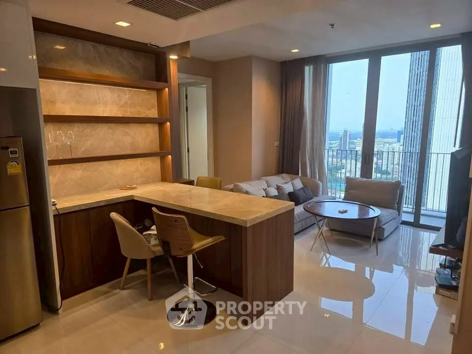 Modern open-plan living room with city view and stylish kitchen