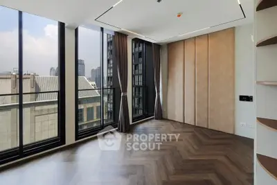 Spacious corner unit with floor-to-ceiling windows offering stunning city views and elegant wood flooring.