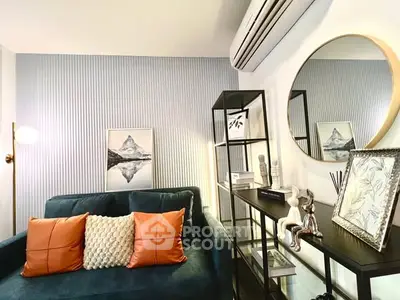 Stylish living room with modern decor, featuring a plush sofa, elegant shelving, and chic wall art.