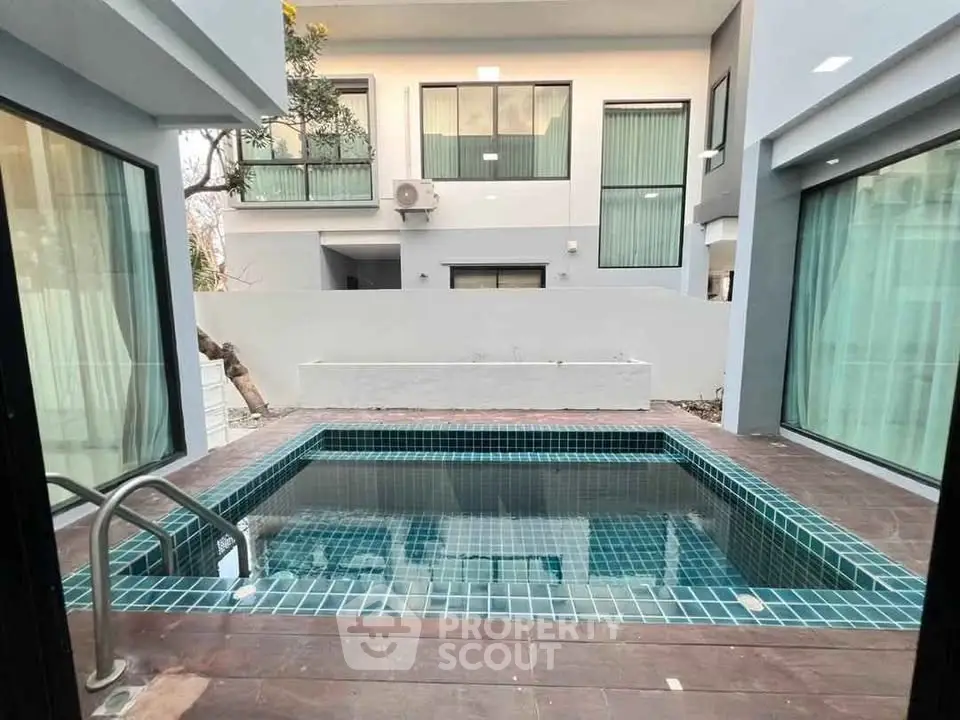 Modern home with private pool and large windows, perfect for luxury living.