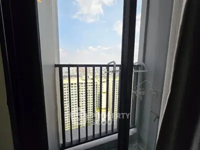 Stunning high-rise balcony view with cityscape and clear skies