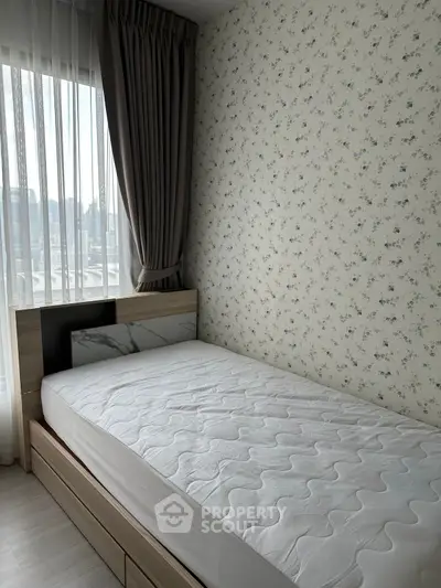Cozy bedroom with single bed and floral wallpaper, featuring a large window with city view.