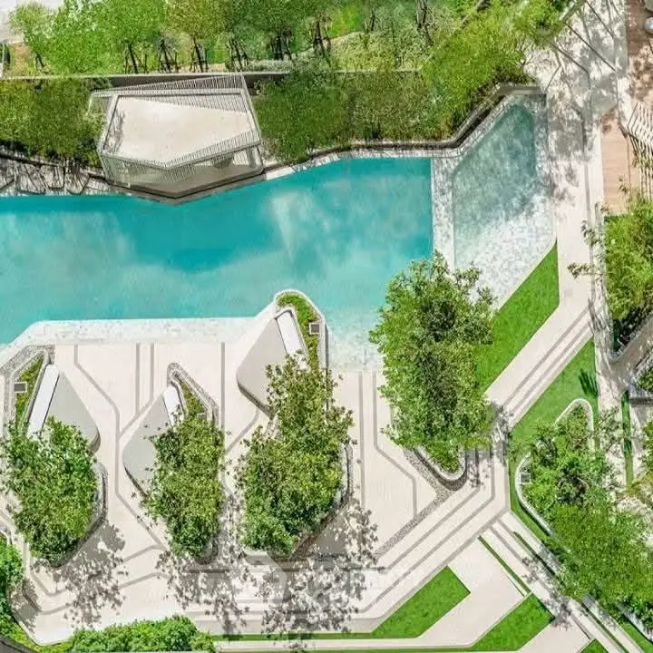 Luxurious aerial view of modern swimming pool with lush greenery and stylish design
