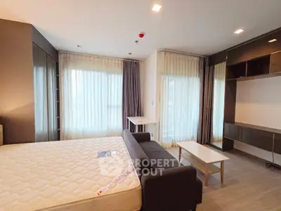 Spacious modern bedroom with large windows and stylish furnishings