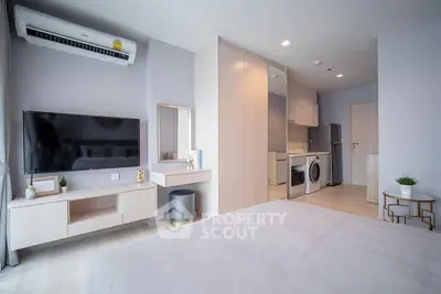 Modern studio apartment with open layout, featuring a cozy bedroom, sleek kitchen, and stylish living area.
