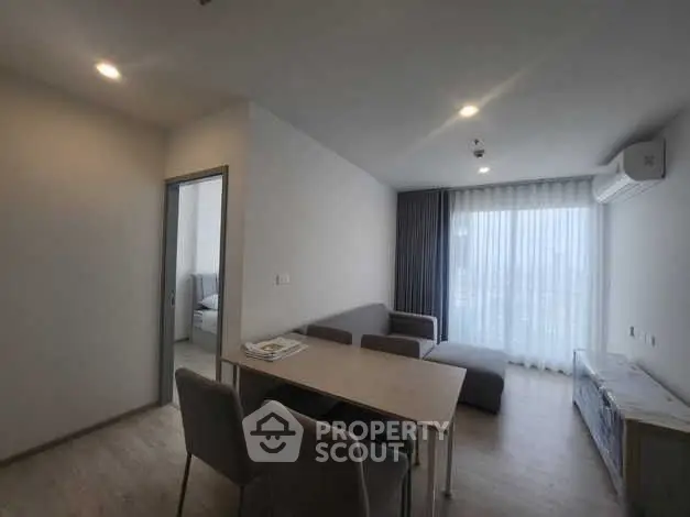Modern living room with dining area and large window view