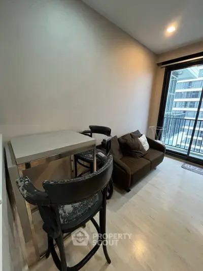 Modern living room with cozy sofa and balcony view in urban apartment