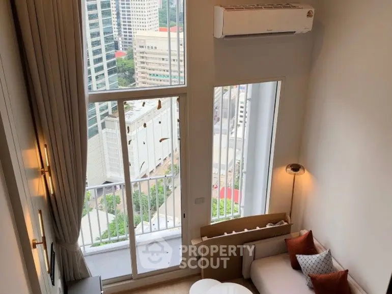 Modern high-rise apartment with floor-to-ceiling windows and city view, featuring a cozy living area.